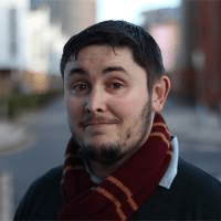 An image of a young man with black hair and a red and yellow gryffindor scarf